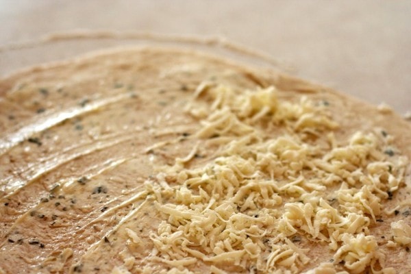 bread dough spread with butter and cheese.