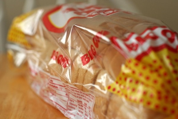What are some benefits of buying from day-old bread outlets?