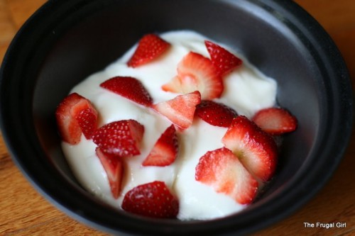 strawberries in a bowl with yogurt.
