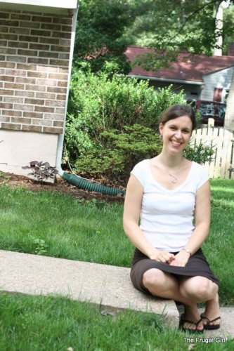 Kristen in a white shirt and brown skirt, smiling at the camera.