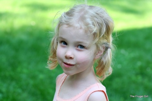 A blonde girl in the shade.