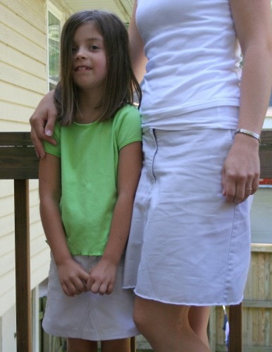 A girl and her mom wearing matching refashioned khaki skirts.