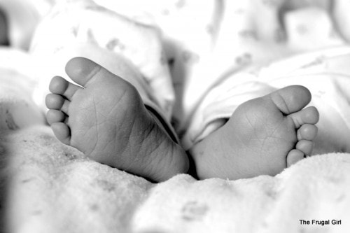 A pair of baby feet in black and white.