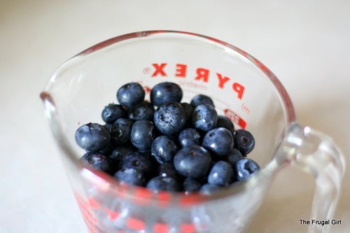 A measuring cup of fresh blueberries.