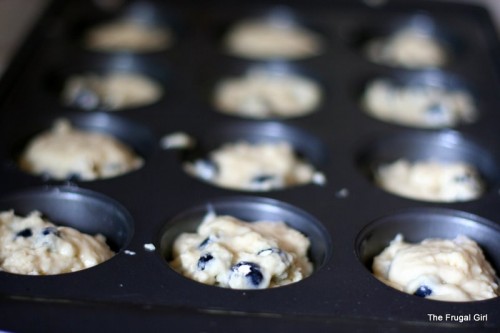 Muffin batter in a muffin tin.