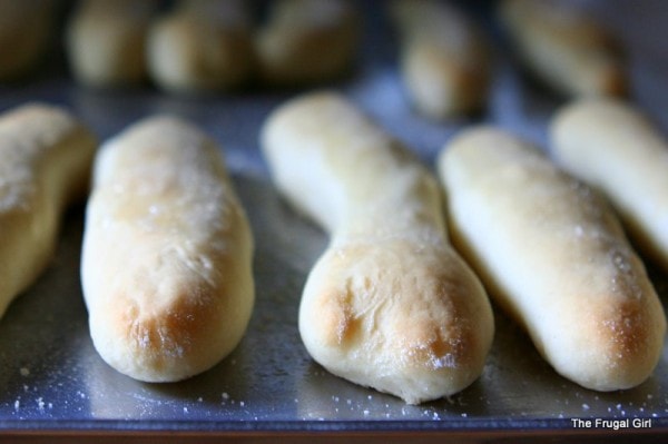 garlic breadsticks on a baking sheet.