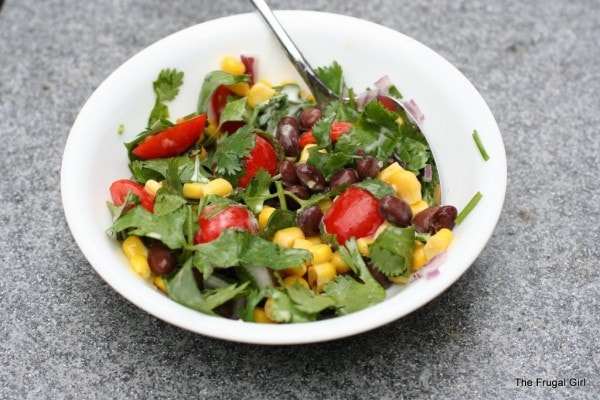 A white bowl filled with a bean salad.