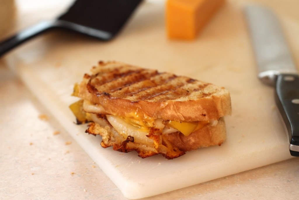 small panini sandwich on a cutting board.