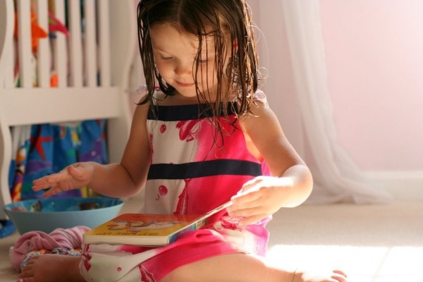 A little girl reading a book.