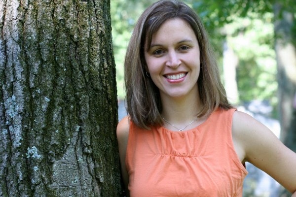 Kristen with highlighted, shorter hair, in an orange shirt.