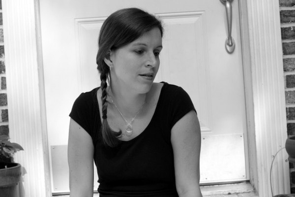 A black and white photo of a woman with two braids.