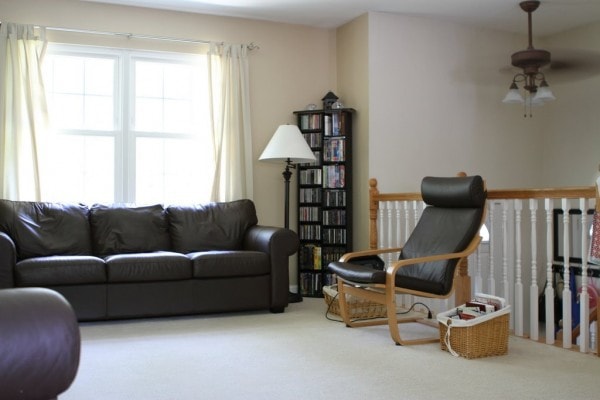 A tidy living room, decorated in neutral colors.