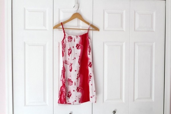 A white and pink fish print dress hanging on white closet doors.