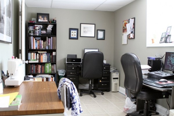 An office wall with a desk and a bookshelf.