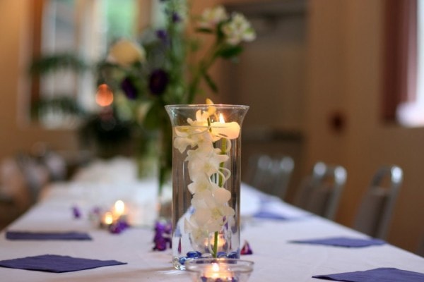 A wedding reception table with a candleholder