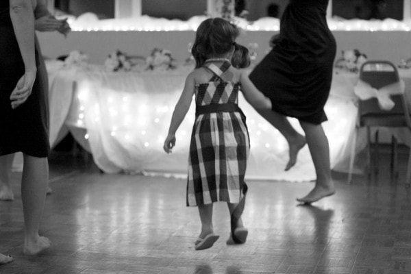 A little girl with pigtails jumping.
