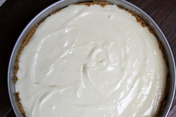 A cheesecake, ready to bake in a springform pan.