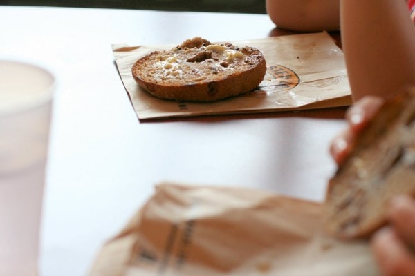 A toasted bagel half on a table.