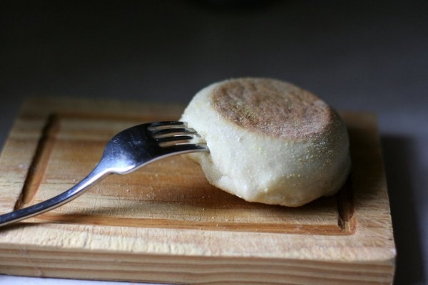A fork splitting an English Muffin