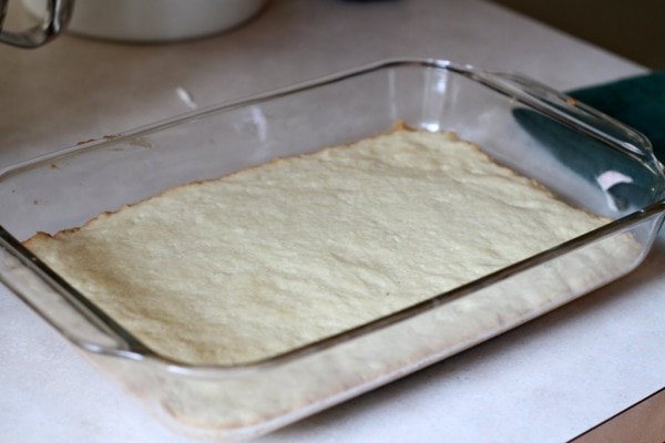A baked shortbread crust in a pan.