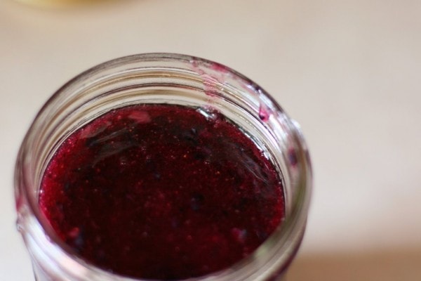 Blueberry jam in a glass jar.