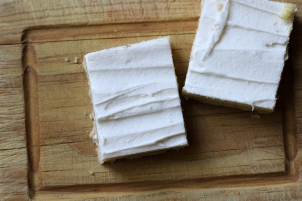 Two almond bars on a cutting board.