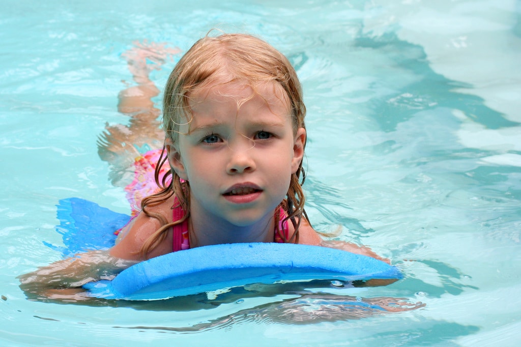 Sonia using a blue inner tube at the pool.