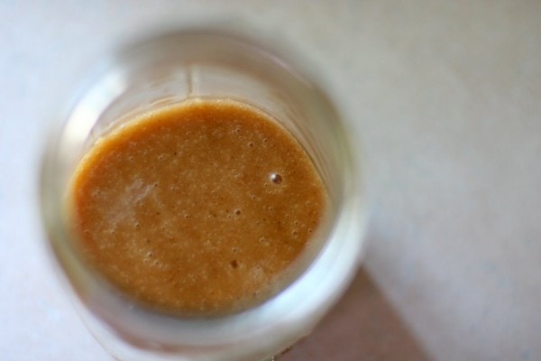 Brown Asian salad dressing in a Mason jar.