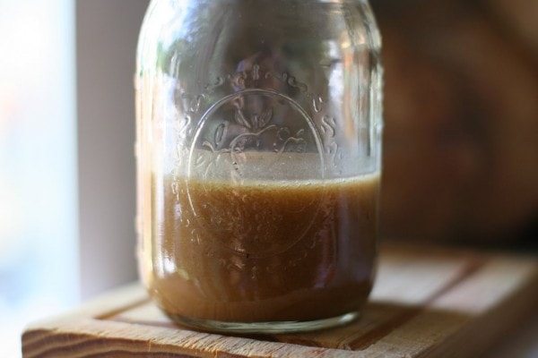 A mason jar of salad dressing.