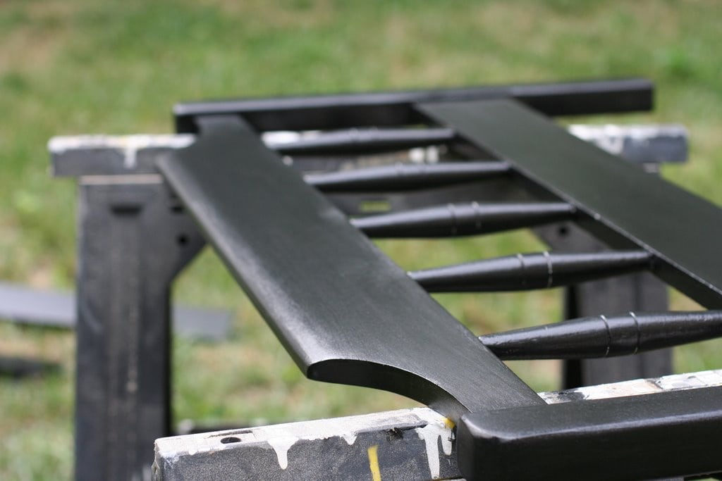 A black painted footboard on saw horses.