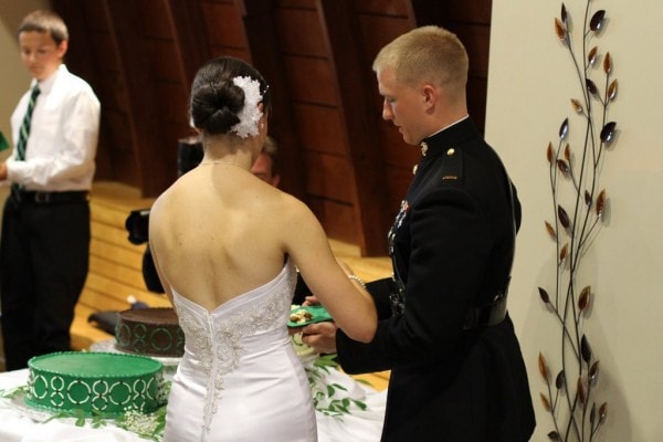 A wedding couple cutting a cake.