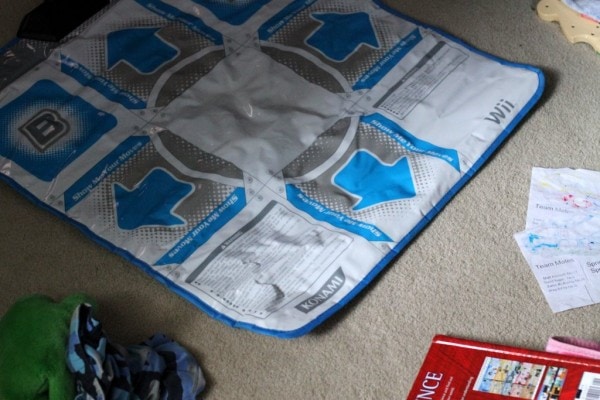 A DDR mat on a carpet floor.