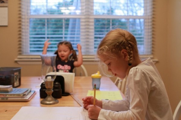 two girls sitting at a table.