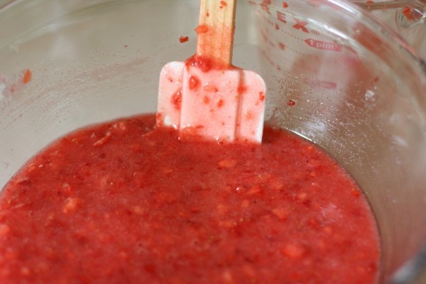 Strawberry jam mixture in a glass bowl.