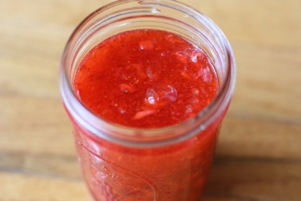 A Mason jar filled with strawberry jam.