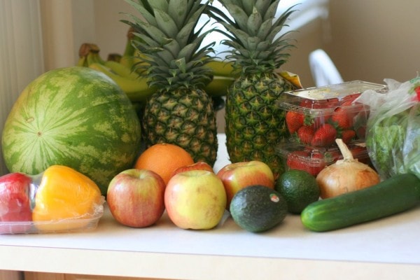 Produce from a grocery shopping trip, arranged on a counter.