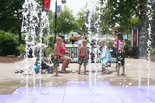 Children playing in splash fountains.