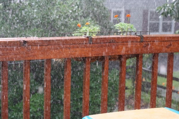 Rain falling on a deck railing