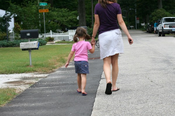 Kristen and Zoe walking hand in hand.