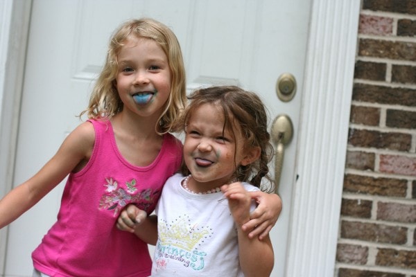 Sisters with blue ice cream tongues.
