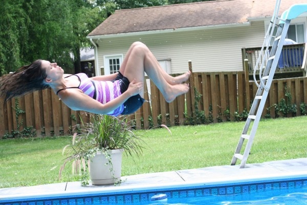 Kristen doing a flip into a pool.