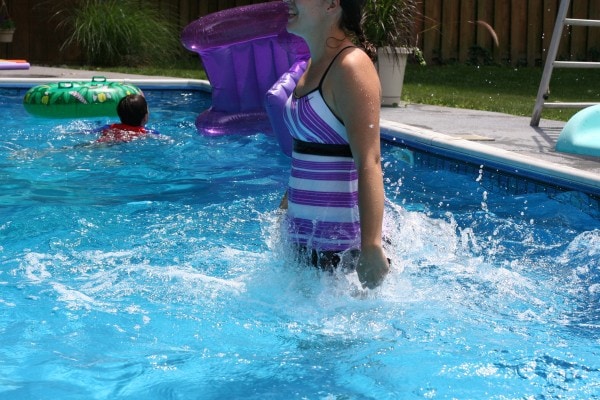 Kristen jumpin in the pool.