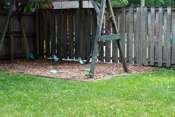 A swingset with mulch underneath.