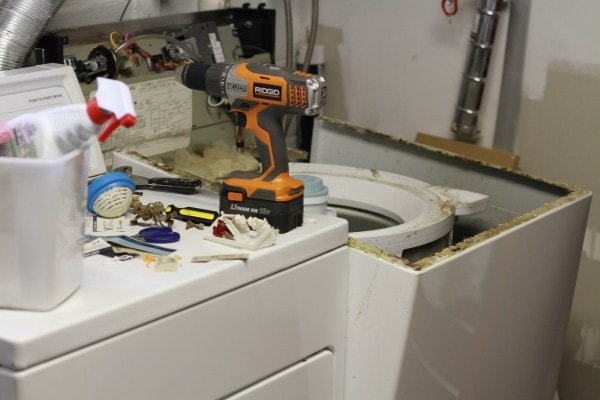 A washing machine in the midst of repair.