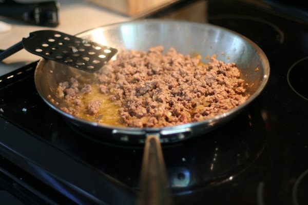 Browned ground beef in a skillet.