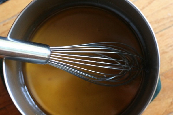 A whisk in a pot.