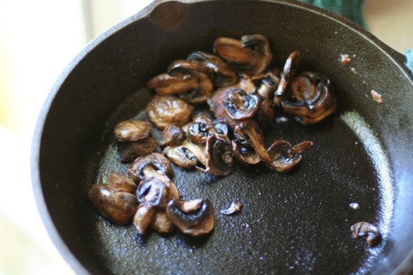 Sauteed mushrooms in a skillet.