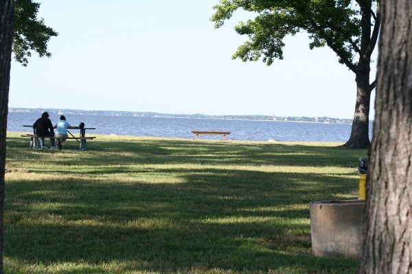 A waterfront view from a picnic bench.