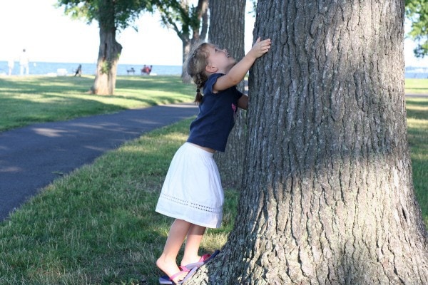 Zoe hugging an oak tree.