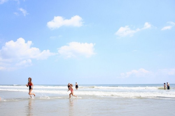 Children play in the waves at Myrtle Beach.